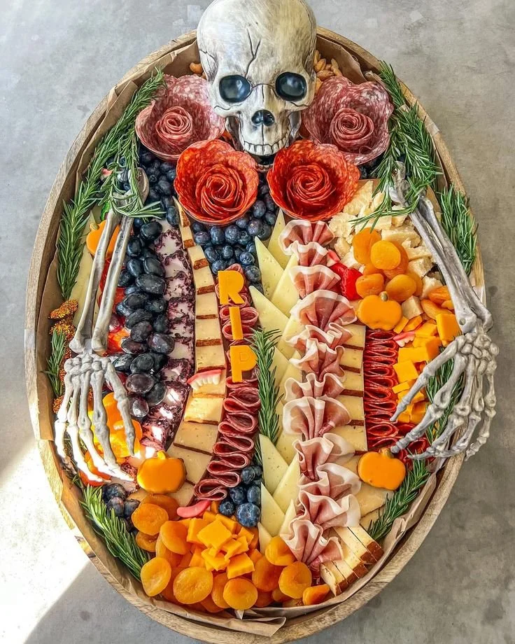Scary Halloween charcuterie board with spooky snacks and decorations